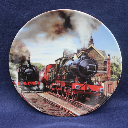 Decorative plate with a steam train design on a blue background