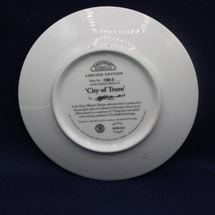 White plate with engraved text on a dark background