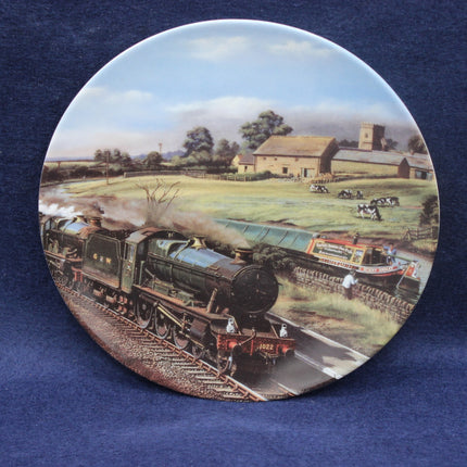 Decorative plate with a steam locomotive and rural scene on a blue background