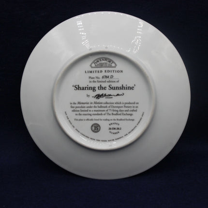 Back of a white plate with text and a logo on a dark background