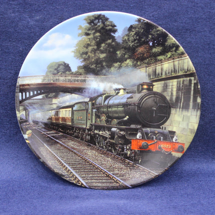 Decorative plate with a steam train design on a blue background