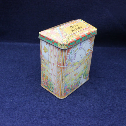 Colorful tin box with decorative design on a dark blue background