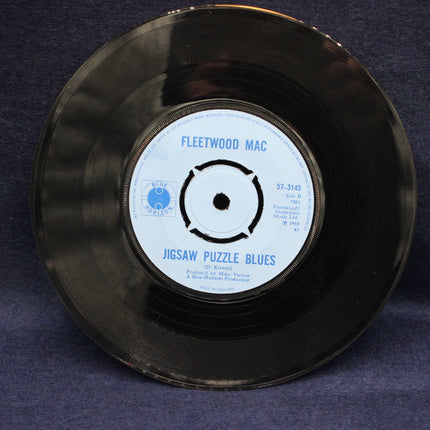 Vinyl record with 'Fleetwood Mac' on a dark blue background