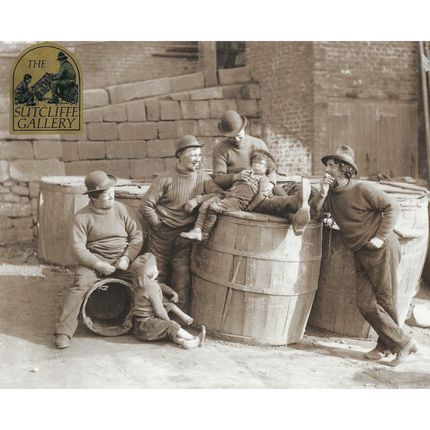 Black and white photograph of men and children around barrels, with 'Sutcliffe Gallery' logo in the corner.