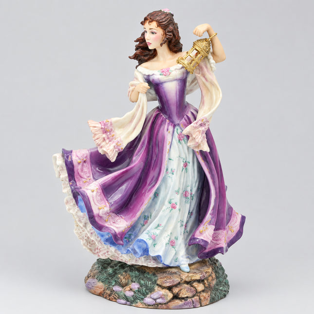 A porcelain figurine of a woman in a flowing purple and white dress holding a gold lantern, standing on a decorative base against a light gray background.