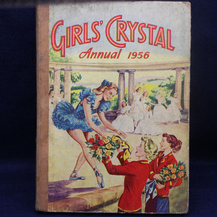 Cover of 'Girls' Crystal Annual 1956' with illustration of a girl in a blue dress and others in a garden setting.