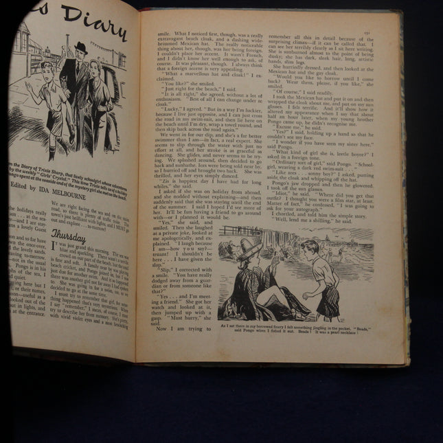 Open book with illustrations and text on a dark background