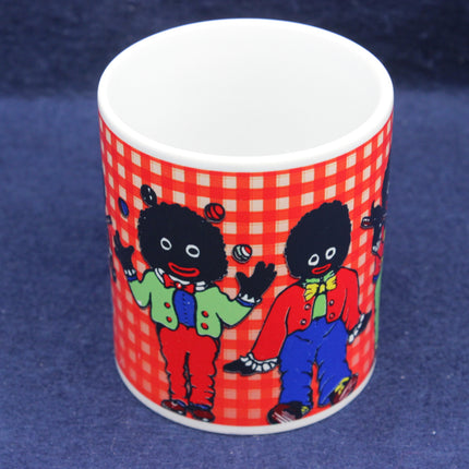 Mug with Golliwog characters on a red and white checkered pattern against a blue background