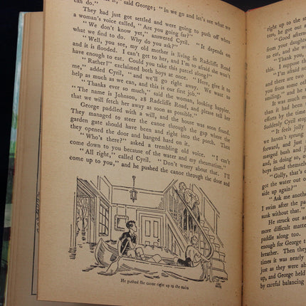 Open book with text and illustration of two people in a boat.