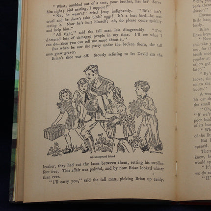 Open book with text and an illustration of a family scene