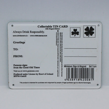 A rectangular collectible tin card with printed text, a barcode, and shamrock symbols, photographed against a plain light gray background.