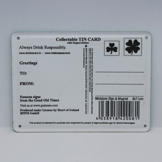 A rectangular collectible tin card with printed text, a barcode, and shamrock symbols, photographed against a plain light gray background.