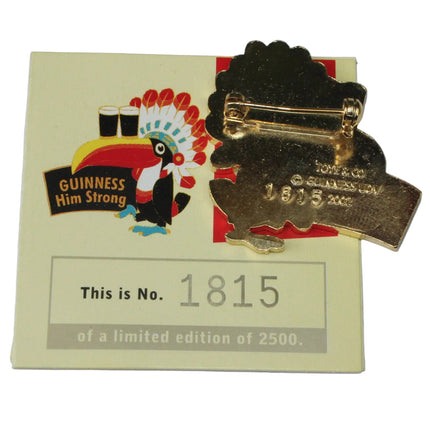 Gold Guinness pin with a label on a white background