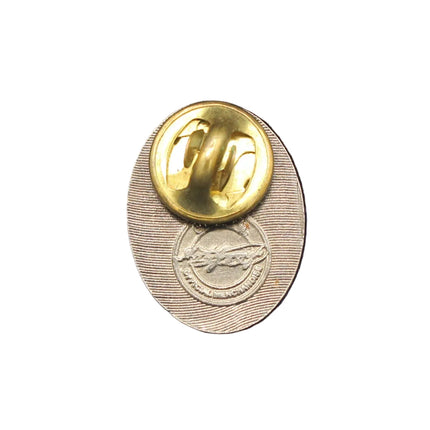 Gold button on a blue textured fabric background