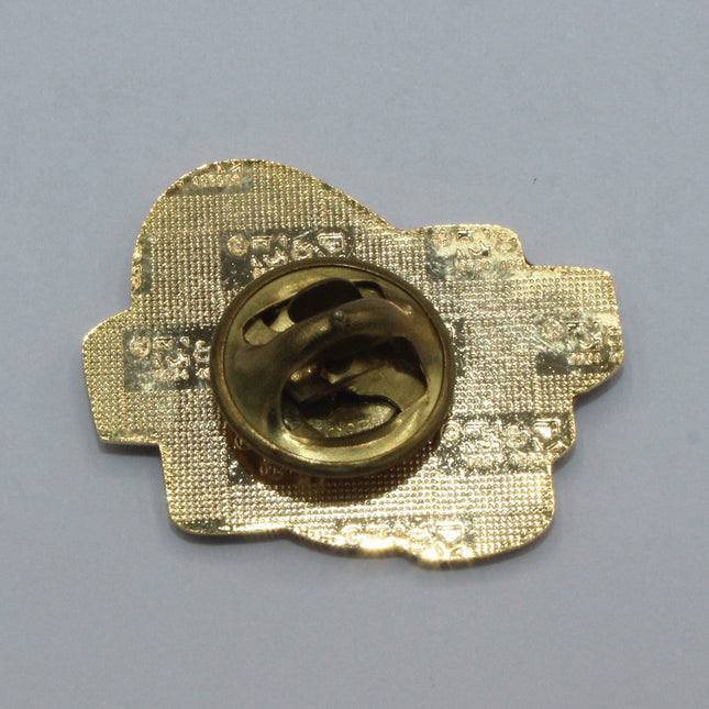 Rear view of a Vintage Guinness Lapel Badge on a grey background