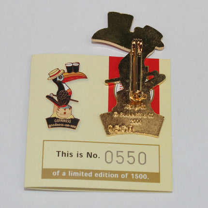 Gold pin with a character design on a card with limited edition details