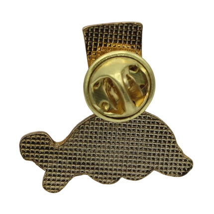 A gold-tone metal Guinness lapel pin shaped like a tortoise, featuring a textured mesh pattern and a round gold-tone clutch backing, shown on a plain white background.