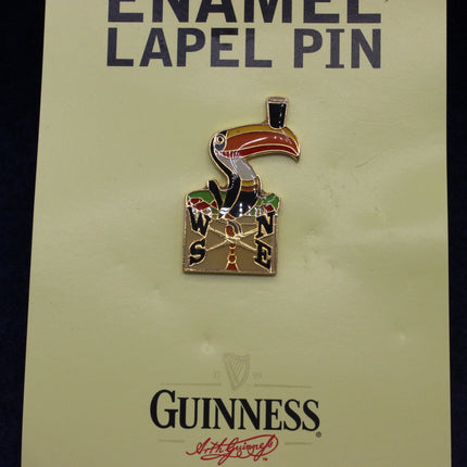 Enamel lapel pin with a toucan design on a GUINNESS branded card.