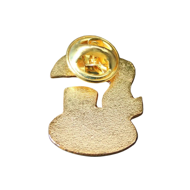 Gold-colored brooch with a unique design on a dark blue background