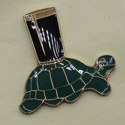 Turtle-shaped lapel pin on a Guinness branded background