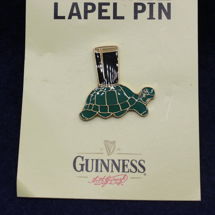 Guinness turtle lapel pin on a branded card