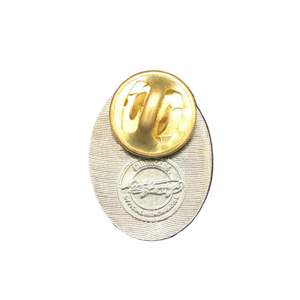 Gold and silver pin on a textured blue background