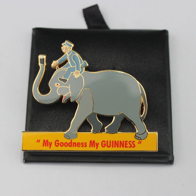 Enamel pin with an elephant and rider on a black card, featuring the text 'My Goodness My GUINNESS'.
