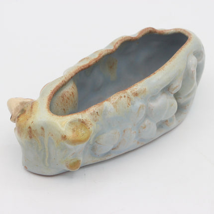 A ceramic planter shaped like a stylized animal head, featuring a pale blue-gray glaze with brown and gold-toned distressed accents, photographed on a white background.