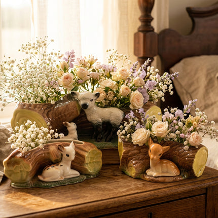 Three ceramic Hornsea Pottery Fauna Collection woodland deer and wolf planter pots shaped like log cross-sections, shown on a bedroom chest of drawers