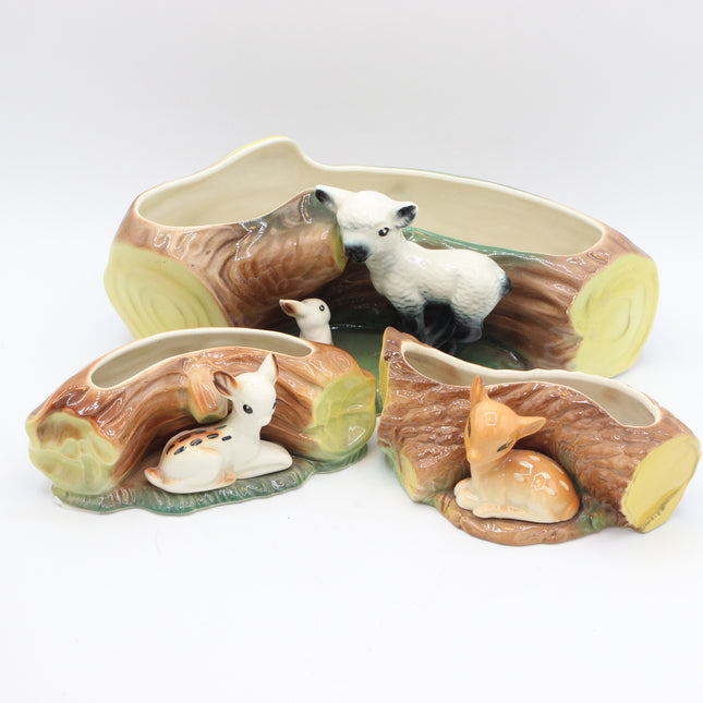 Three ceramic woodland deer and wolf planter pots shaped like log cross-sections, shown on a clean white background.