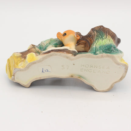Vintage ceramic hornsea figurine showing a small orange lobster under a green and brown shell on a white background, with 'HORNSEA ENGLAND' embossed on the base.