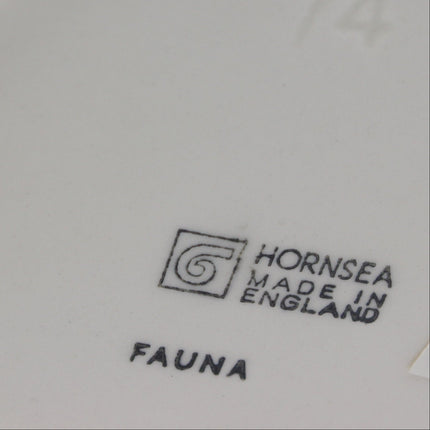 Close-up of the underside of a ceramic plate or dish, showing the brand mark 'HORNSEA MADE IN ENGLAND', the collection name 'FAUNA', and a faint '74' marking.