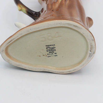 Close-up of the bottom base of a brown ceramic horn-shaped pitcher or jug, showing the interior glaze and printed maker's mark reading Hornsea Reed.