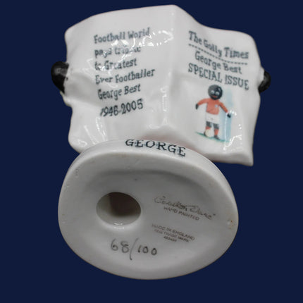 Ceramic  Golly sculpture  George with a newspaper with text and graphics on a blue background