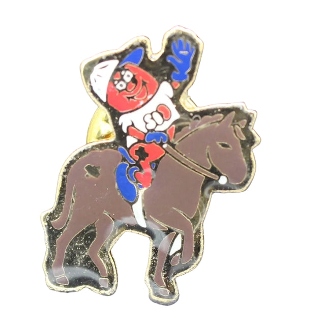 Pin with cartoon character on a horse against a blue textured background