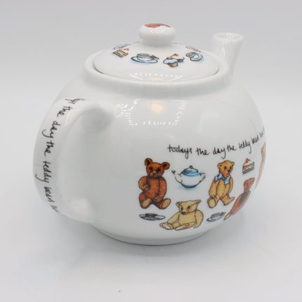 A white ceramic teapot decorated with Winnie the Pooh bear illustrations, a teapot, and the quote 'todays the day the teddy bear was best' on a light gray background.