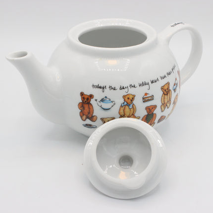 A white ceramic teapot with a matching lid, decorated with teddy bear illustrations and a quote on a clean white background.