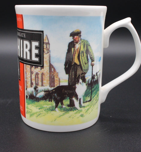 Mug with a vintage design of a man with dogs and a building on a label.