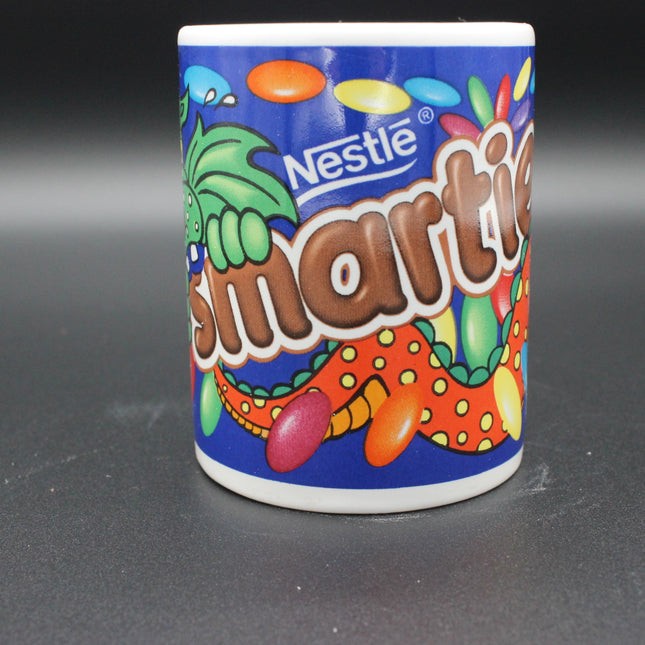 Nestle Smarties candy mug on a dark background