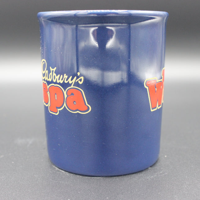 Blue mug with Cadbury's Wispa branding on a gray background