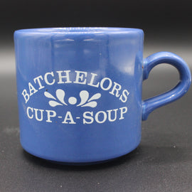 Blue mug with 'BACHELORS CUP-A-SOUP' text on a dark background