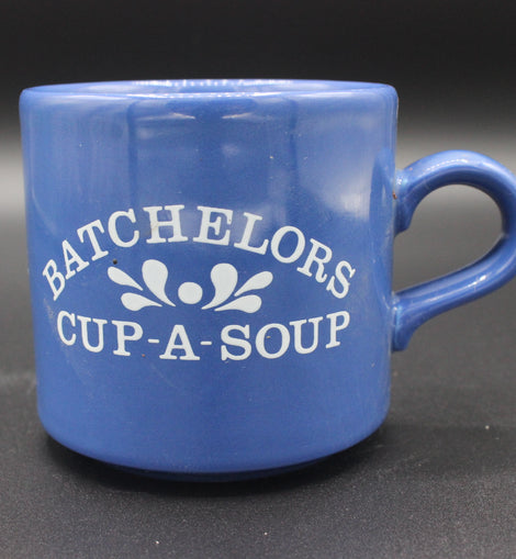 Blue mug with 'BACHELORS CUP-A-SOUP' text on a dark background