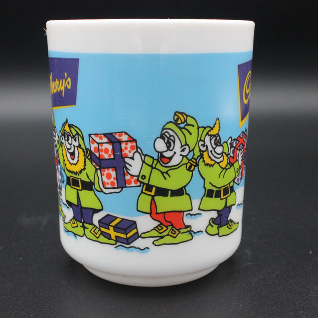 Ceramic mug with cartoon elf character design on a black background