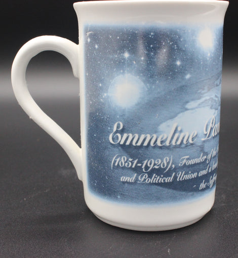 White mug with a blue celestial design and text on a dark background