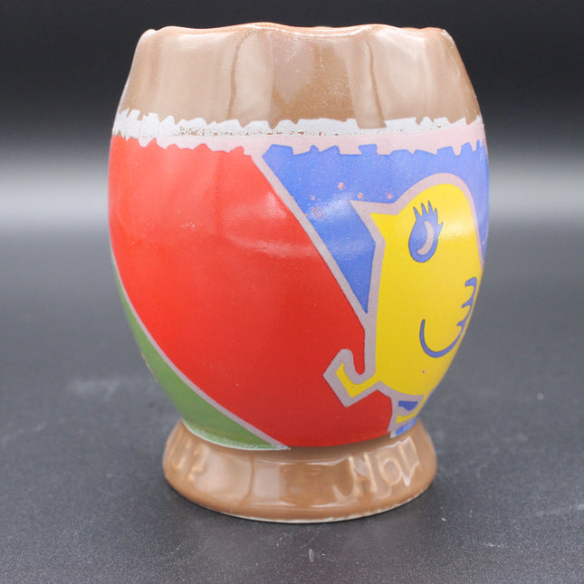 Colorful ceramic cup with a chicken design on a grey background