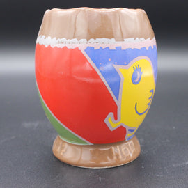 Colorful ceramic cup with a chicken design on a grey background