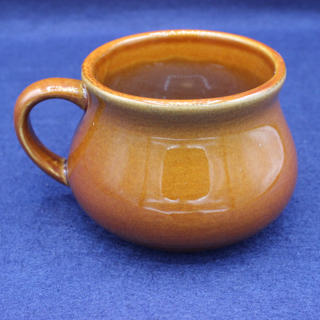 Brown ceramic mug on a blue background
