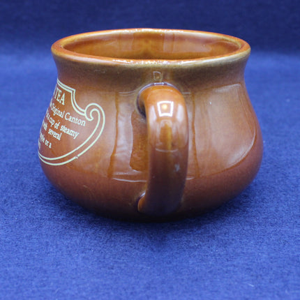 Brown ceramic mug with a handle on a blue background