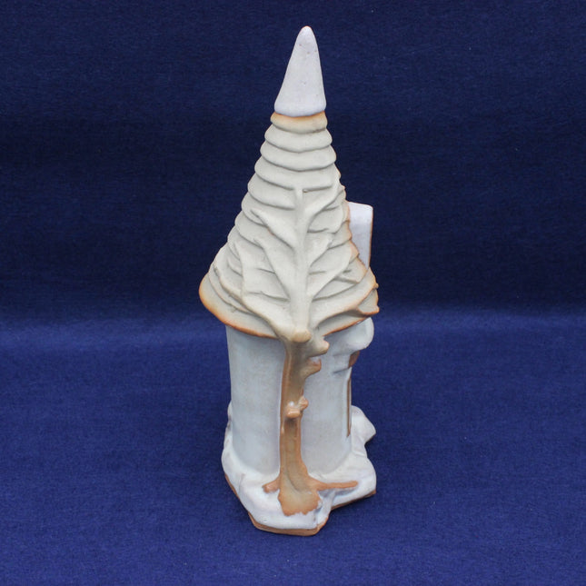 Ceramic sculpture of a stylized tree on a blue background