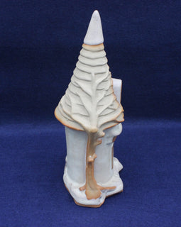 Ceramic sculpture of a stylized tree on a blue background